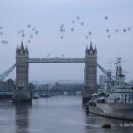 Up to 50 hot air balloons glide over the Thames at sunrise
